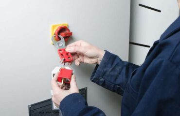 Woman worker locking out electrical box