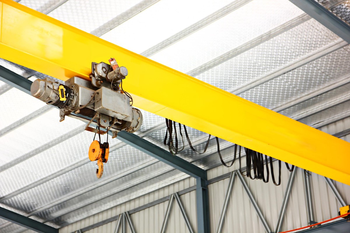 Overhead crane system highlighting structural components, lifting mechanism and the importance of understanding load limits and suspended load risks in construction environments.
