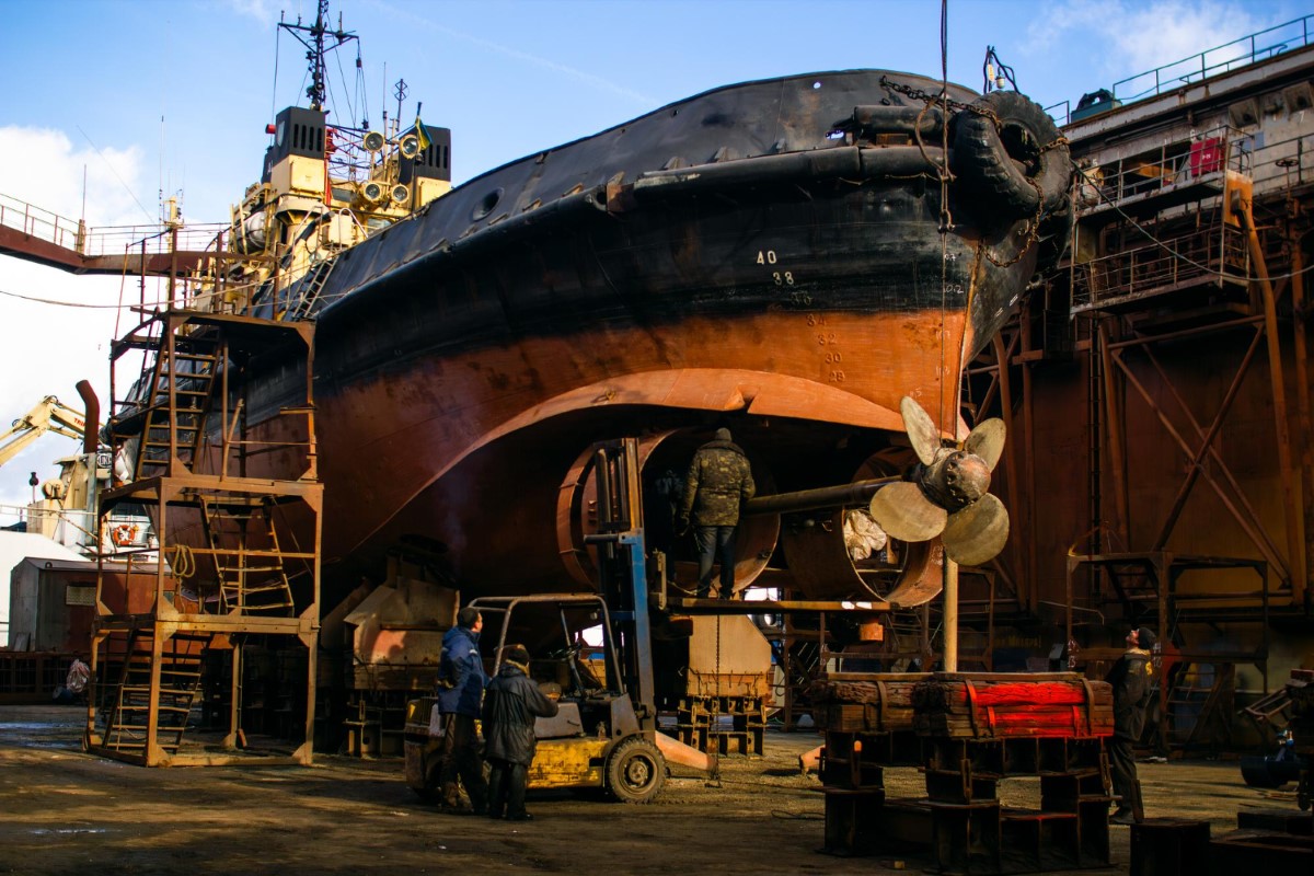 Dry dock maintenance activities showing simultaneous operations, structural access routes and EPC requirements for safe naval repair environments.