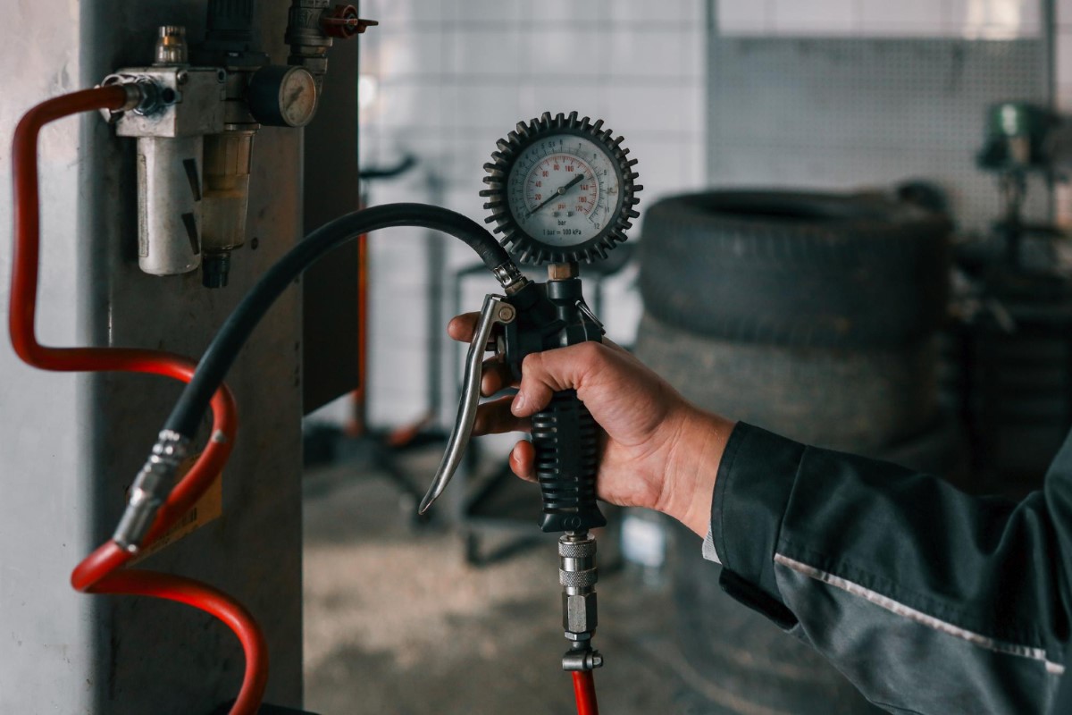 Operator checking an air pressure regulator to maintain safe pneumatic performance in hyperbaric environments.