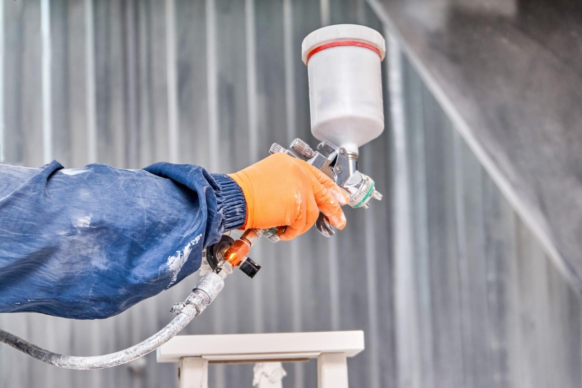 Precision spraying technique demonstrating controlled application and proper handling of pressurized equipment.
