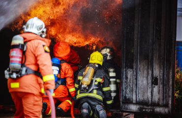 The Back side view of a group of teamwork firefighters helped Fire Brigade Course