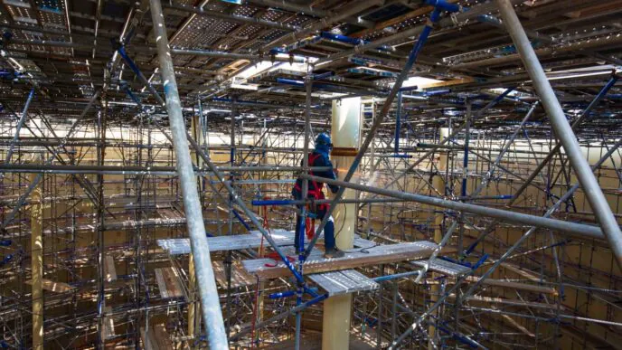 Andaimes industriais com múltiplos pontos de apoio e plataformas móveis. O dimensionamento correto de contraventamentos evita colapsos e garante estabilidade em ambientes críticos.